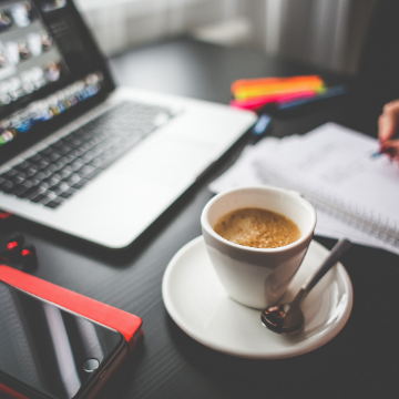 coffee and open laptop on a desk