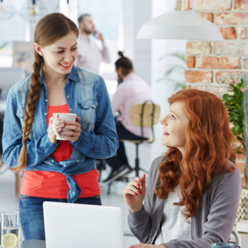 two female work colleagues chatting