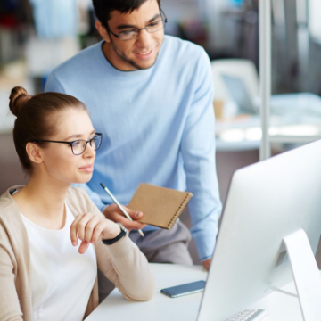 two work colleagues looking at computer screen