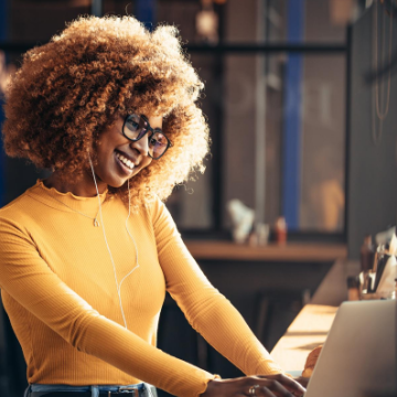 Woman smiling at her laptop screen