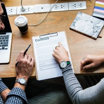 two colleagues reviewing a job contract
